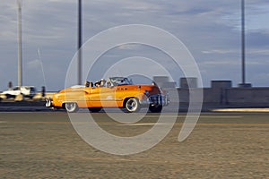 LA HABAN, CUBA - Aug 14, 2019: auto antiguo anaranjado en atardecer photo