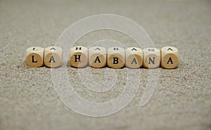 la habana word built with wooden cubes and black letters on the floor and bottom of sand beach photo