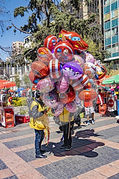 man sells balloons filled with gas for children in La Paz