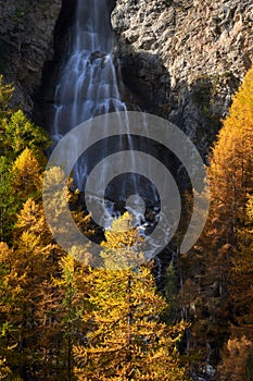 La Pisse waterfall in Autumn in the Queyras Regional Natural Park. Ceillac, Hautes-Alpes, Alps, France