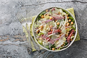 La Scala Chopped Salad with simple ingredients like chopped romaine, salami, and mozzarella close-up in a bowl. Horizontal top photo