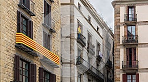 La Senyera `flag` in Catalan and mannequin on the balconies in Gothic Quarter of Barcelona