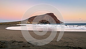 La Tejita beach at sunset with Montana Roja hill in the background. photo