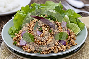 Laab gai or larb gai, spicy minced chicken breast salad, healthy food dish in Isan Thai food style