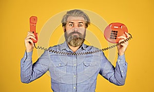 lab of advertisement. brutal guy with telephone. mature bearded man talk on retro phone. vintage technology in modern