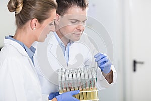 Lab assistants in research laboratory preparing samples for scientific test