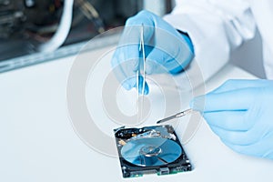 Lab engineer working on broken hard disk