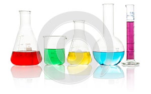 Lab glassware with liquids on white