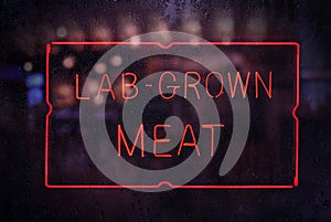 Lab-Grown Meat Sign in Rainy Shop Window photo