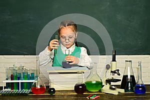 Lab microscope and testing tubes. Little kids scientist earning chemistry in school lab. It was a little chemistry