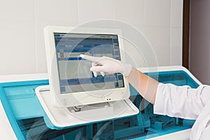 Lab tech loading samples into a chemistry analyzer