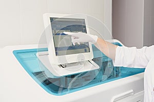 Lab tech loading samples into a chemistry analyzer