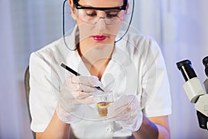 Lab technician assistant analyzing urin sample at laboratory. photo