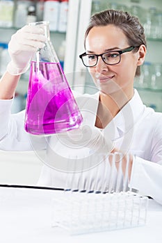 Lab technician holding flask