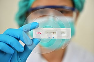 Lab technician holding HIV rapid device test