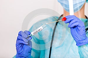 Lab technician holding swab collection kit,Coronavirus COVID-19 specimen collecting equipment,DNA nasal and oral swabbing for PCR