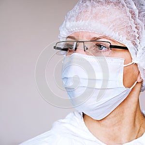 Lab technician, medic. Jar for analysis. On the face of a protective mask. Glasses. Protective suit.