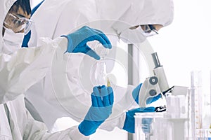 Lab Technician in Personal protective equipment  PPE suit Vaccines testing of Virus in Laboratory