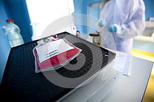 Lab technician processes blood bag