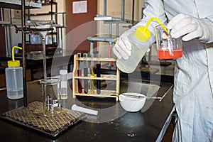 Lab Technician's Hands in Gloves Dilution Red Liquid