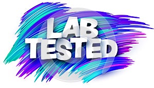 Lab tested paper word sign with blue paint brush strokes over white