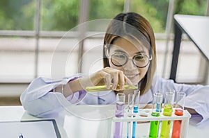 Lab Testing Products By a chemist women are enjoying chemistry experiments, liquid colors for cosmetics and icons to develop safe