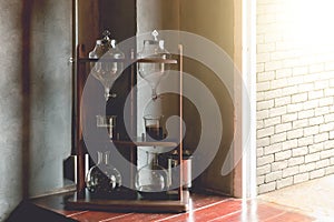 Lab tube and equipment on wooden table, cold brew coffee