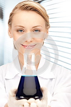 Lab worker holding up test tube