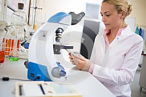 Lab worker look for chemical data at ipod
