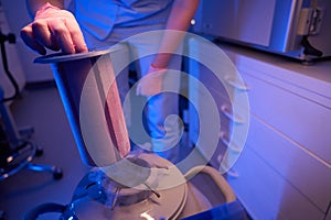 Lab worker using cryogenic container for preservation of biological material