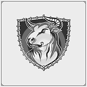 Label with aggressive bull. Corrida emblem. Print design for t-shirt.