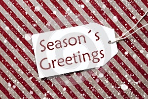 Label On Red Paper, Snowflakes, Text Seasons Greetings