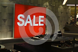 Label SALE in the department store - Saleâ€™ signs, hanging in a large department store