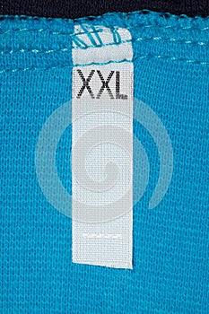 Label size XXL on blue cloth.