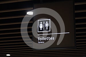 Label of symbol of toilet for men and women on blue plate, direction  sign and navigation pointer WC restroom in building, airport