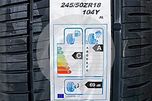 Label on tire with information about level of noise, braking distance and fuel efficiency