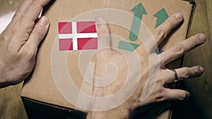 Labeling carton with the Danish flag sticker. Import or export in Denmark