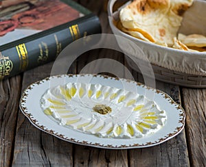 Labneh or labna served in a dish isolated on wooden background side view of appetizer