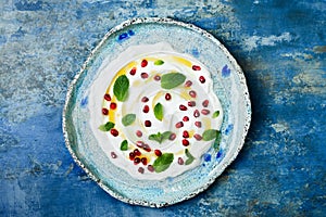 Labneh middle eastern lebanese cream cheese dip with pomegranate, molasses and mint. Top view