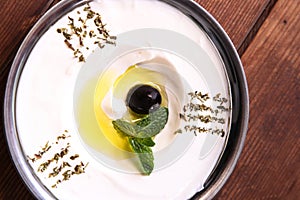 Labneh served in dish isolated on background top of arabic food cold mezza photo