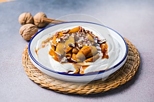 Labneh yogurt cream cheese with roasted apples, copy space. Traditional arabian or middle eastern homemade labneh dip. Greek