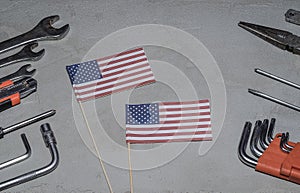 Labor Day in America, May 1. Many handy tools on concrete background with flag of America with copy space