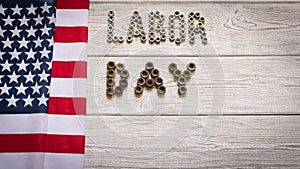 Labor day. American flag and Inscription labor day on a light wooden background