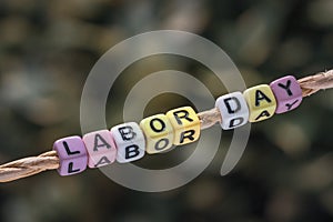 Labor day background concpet. Labor Day word hanging by a rope w