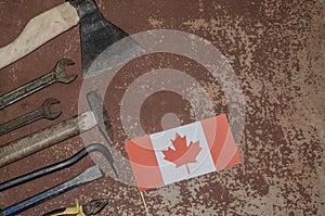 Labor Day in Canada, May 1. Lots of handy tools on old rusty background with Canada flag with copy space