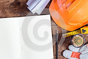 Labor day concept.Construction safety equipment and blank notebook or notepad on wooden table