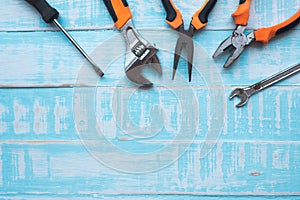 Labor day Concept. Construction tools on blue wooden background