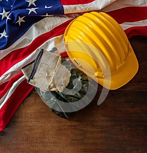 Labor day. Construction helmet and USA Flag on wood, top view. Holiday celebration