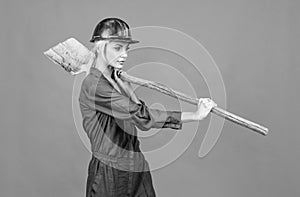 labor day. copy space. woman in boilersuit and helmet. female builder hold shovel.