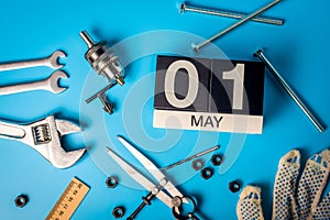 Labor day. May 1st. Day 1 of may month, calendar on blue background with tools